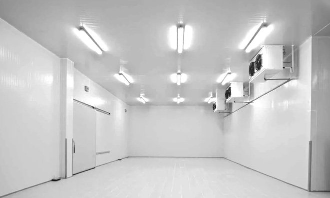 Finished cold room interior with white insulated panels, sliding door and ceiling evaporators