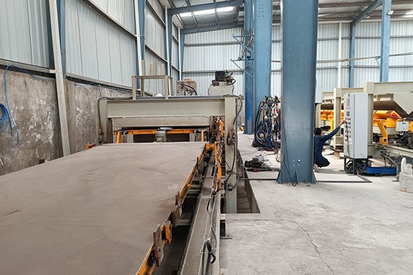 Wide view of the sandwich panel production line at Vahrk’s plant, with an operator at the line