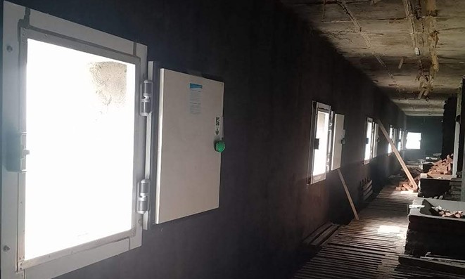 Insulated PUF door installed in a cold room under construction